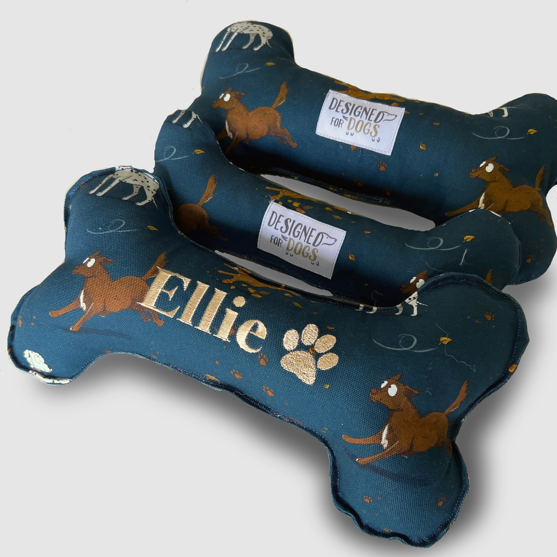 Teal bone shaped dog toy with Terrier, Dalmatian and Brown Dog Design.