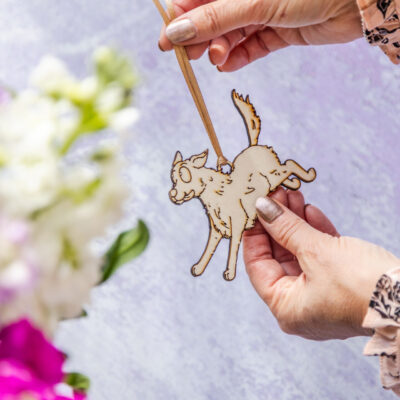 Fluffy dog-shaped wooden decoration with rustic finish.