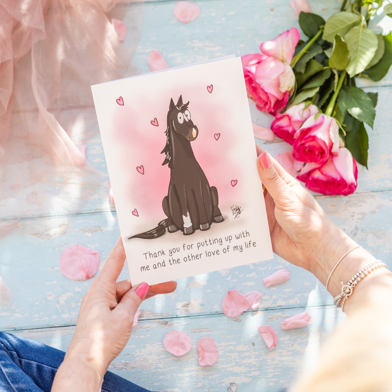 women's hands holding an A5 greeting card with a brown horse on and the text 'thank you for putting up with me and the other love of my life