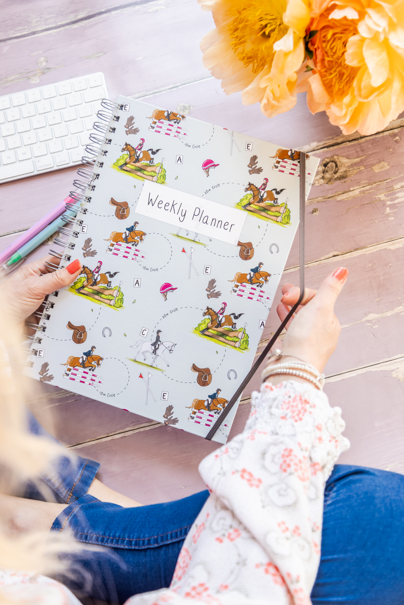 A4 Weekly planner book with eventing horse design being held in hands
