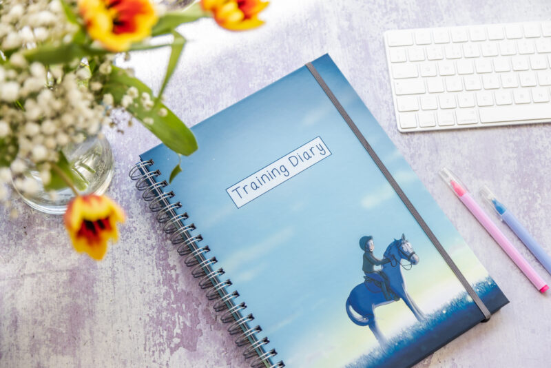 Training diary with a horse and rider on the front.