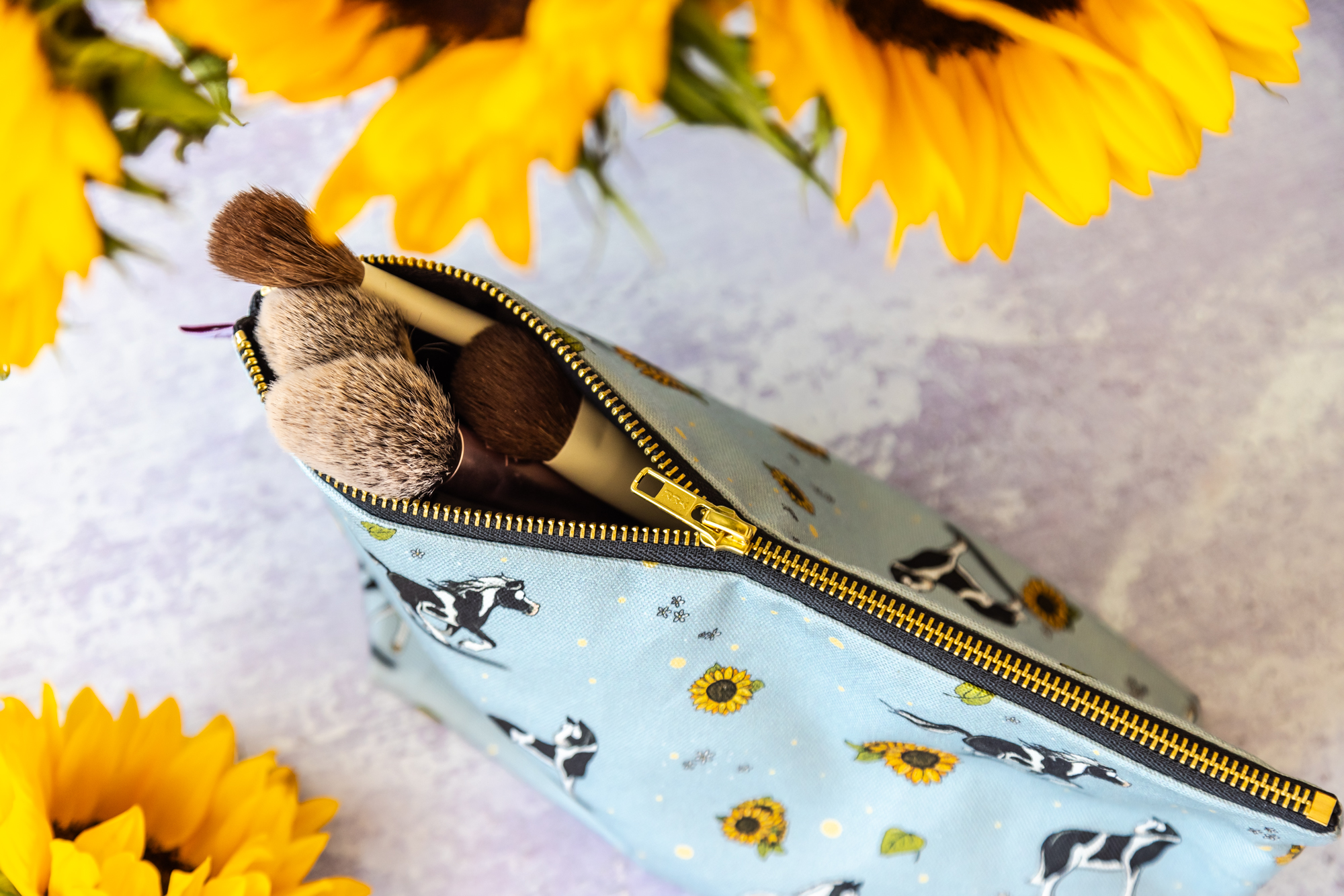 Durable zip of blue cotton washbag. Decorated with a Piebald Horse design featuring a Hogged Piebald Horse, Piebald Cob and Piebald Sport Horses, with Sunflowers.