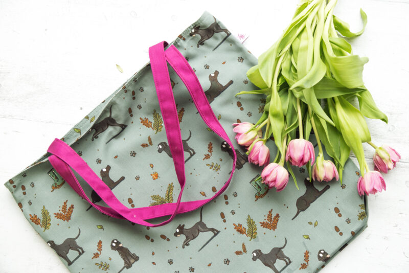 Oversized black Labrador Tote Bag by Emily Cole Illustrations. Black Labradors on a green background. Lined and zipped tote bag.