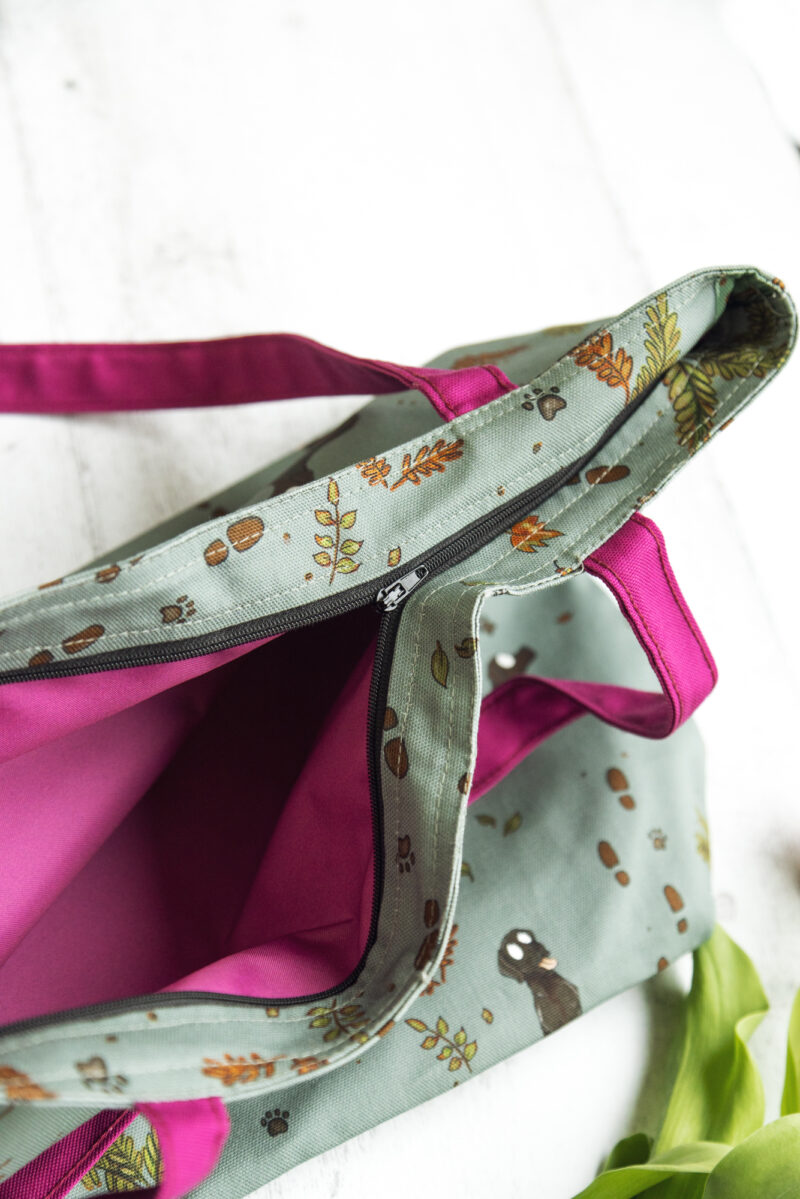 Oversized black Labrador Tote Bag by Emily Cole Illustrations. Black Labradors on a green background. Lined and zipped tote bag.