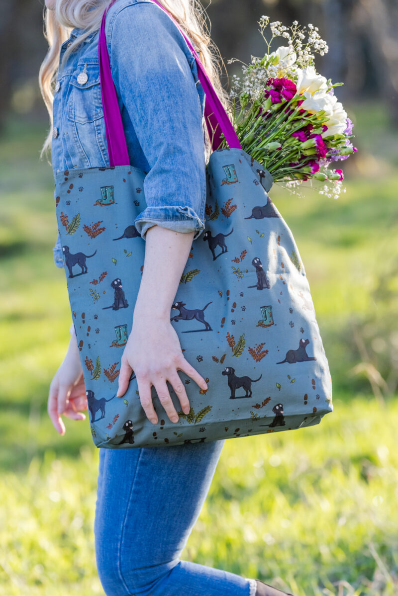 Oversized black Labrador Tote Bag by Emily Cole Illustrations. Black Labradors on a green background. Lined and zipped tote bag.