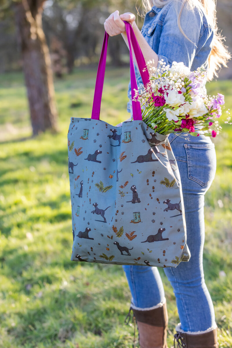 Oversized black Labrador Tote Bag by Emily Cole Illustrations. Black Labradors on a green background. Lined and zipped tote bag.