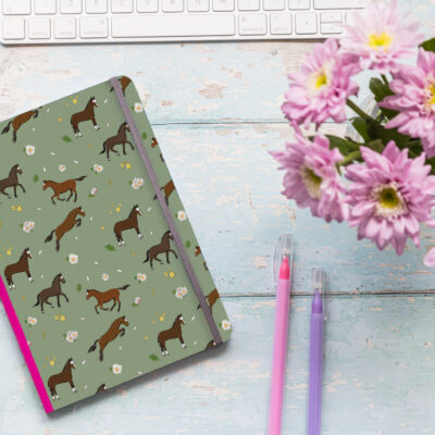 A5 soft cover notebook with bay horse pattern and pink elastic closure.