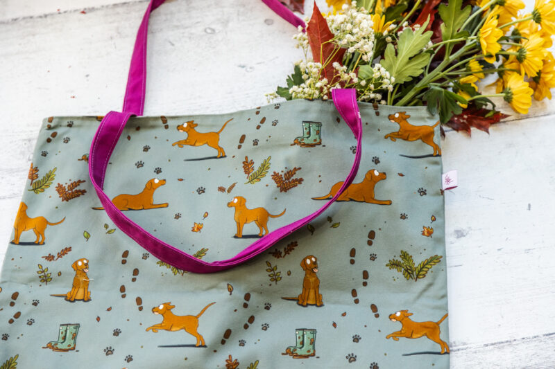 Oversized red fox Labrador Tote Bag by Emily Cole Illustrations. Yellow Labradors on a green background. Lined and zipped tote bag.