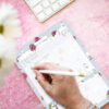 Close-up of grey horse patterned A5 to-do list notepad with pen and checked tasks.