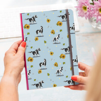 A5 soft cover notebook featuring a piebald horse pattern across the front, ideal for horse lovers and equestrians.