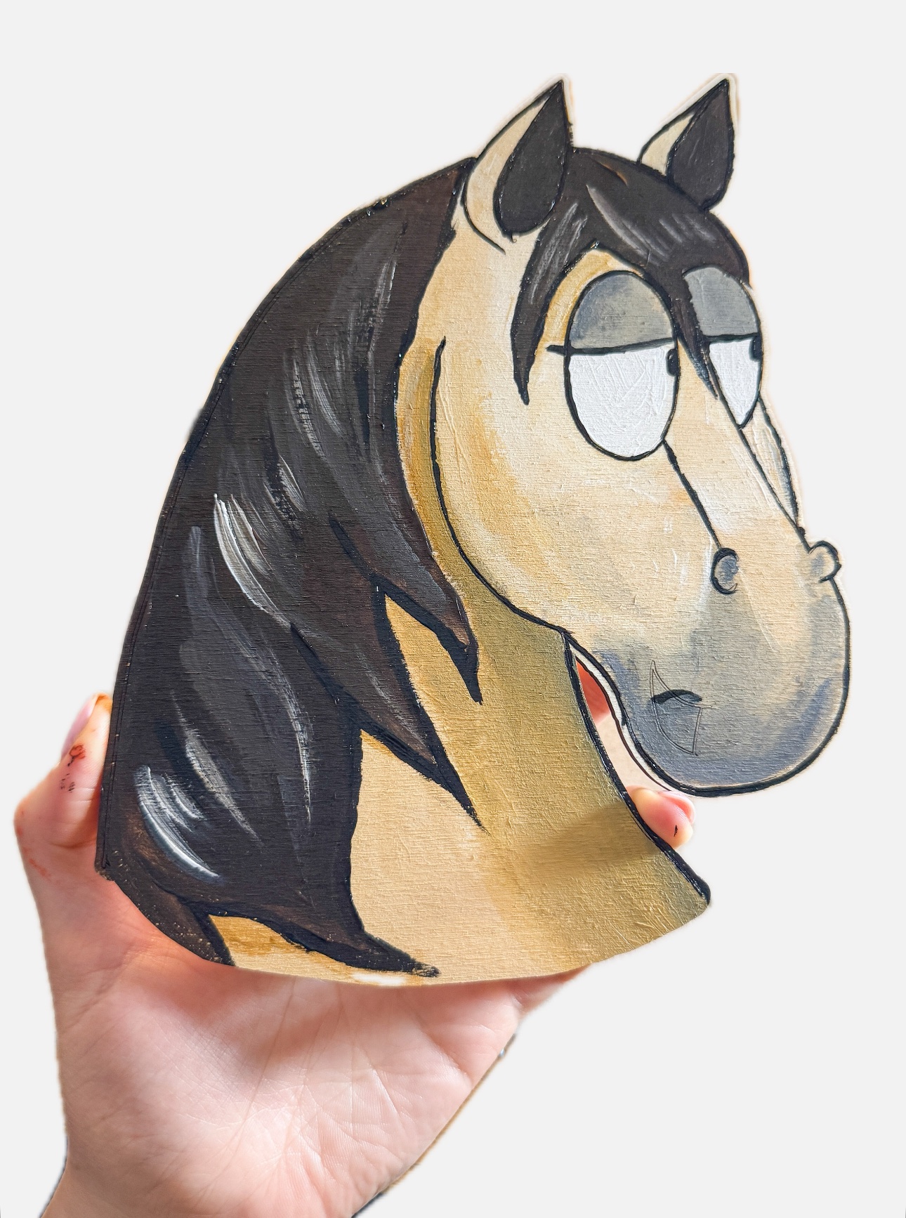 Painted medium wooden horse head with decorative details.