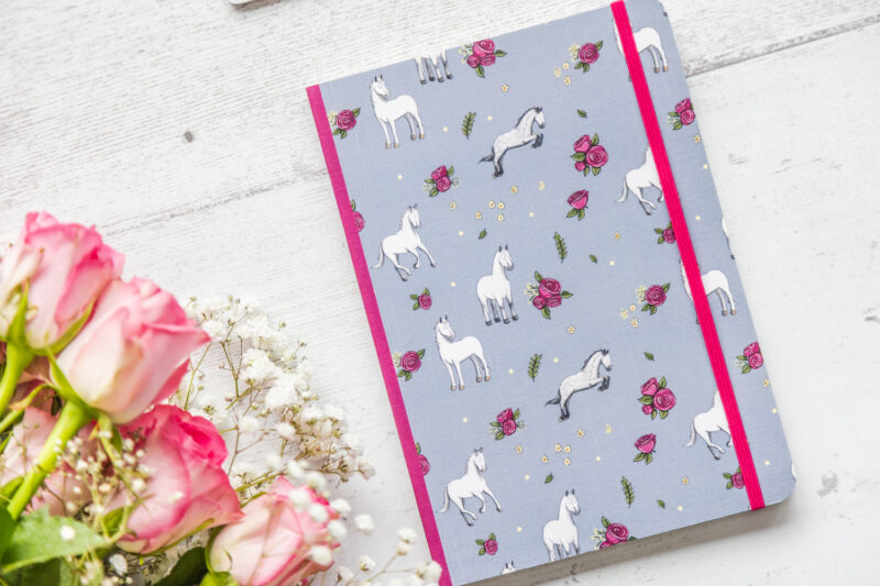 Grey horse patterned notebook angled view