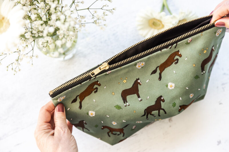 Bay horse wash bag. Brown horses on a green background fabric zipped and lined makeup bag by Emily Cole Illustrations
