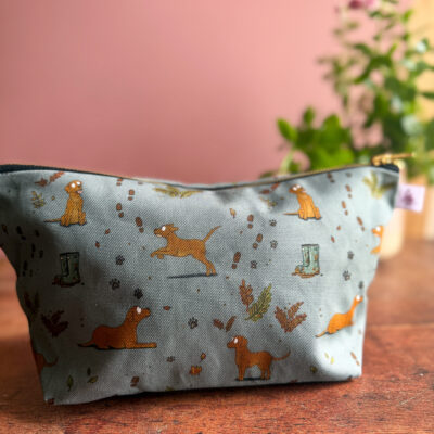 Wash bag with fox red Labrador print and muddy paw prints on a sage green background