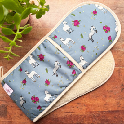 Full view of double oven gloves with grey horses and roses on dusty blue background