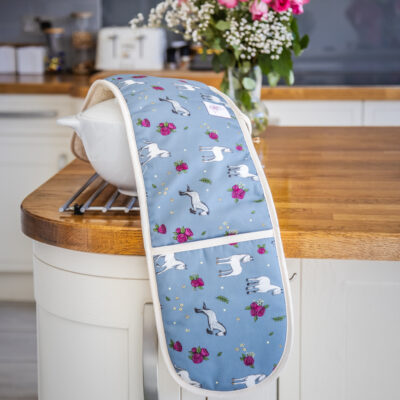 Full view of double oven gloves with Grey horse and rose pattern on blue fabric